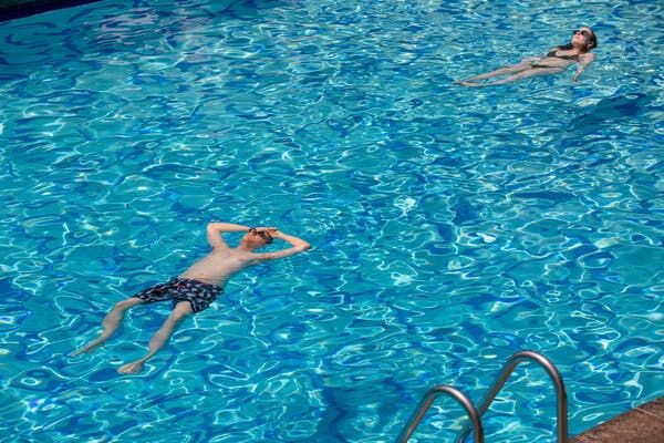 Guests swim in the Tropicana Pool at the Hollywood Roosevelt Hotel in Los Angeles on Tuesday.