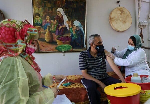 A Palestinian receiving a vaccine this month in the village of Dura, near Hebron, in the West Bank.