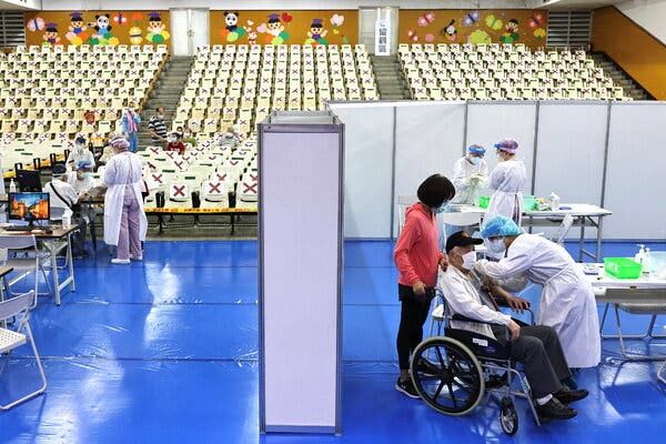 A medical worker administers a dose of the AstraZeneca Covid-19 vaccine New Taipei City, Taiwan on Wednesday. The island is facing a vaccine shortage during its first major outbreak of the virus.