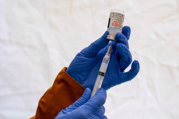 Preparing a Moderna Covid-19 vaccine in Seattle.