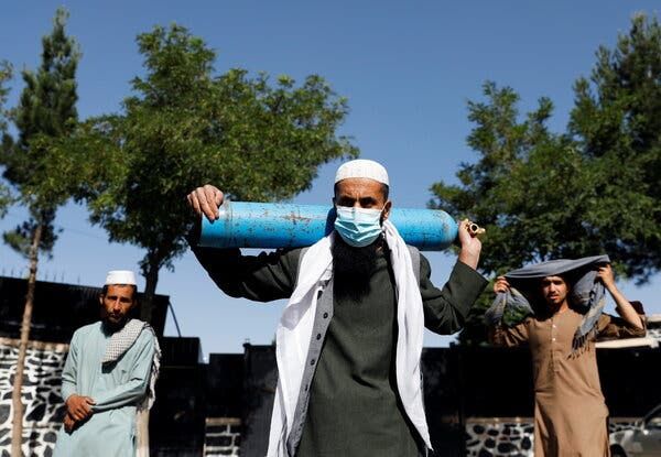 A man waiting to get his oxygen cylinder refilled in Kabul on Tuesday. The U.S. Embassy has gone into lockdown amid an outbreak among its workers. Coronavirus cases are surging throughout Afghanistan.