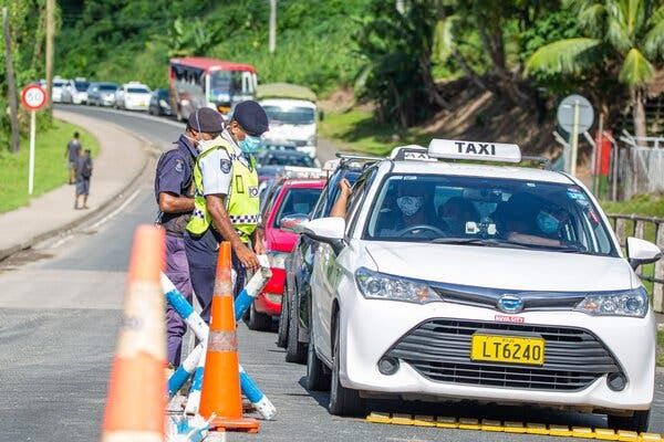 Police officers checking cars in Suva, Fiji, in late April. The island nation, with a population of about 900,000, now has more than 1,000 known active cases of the coronavirus.