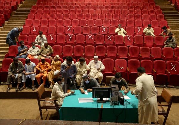 Government employees waiting for vaccines in Peshawar on Friday. The government in another Pakistani province, Sindh, said it would stop paying unvaccinated government workers.