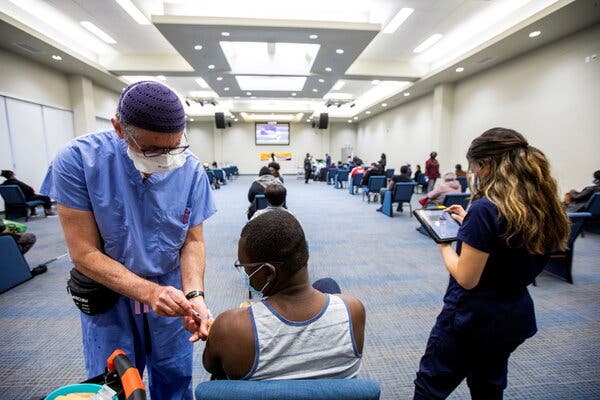 A health care worker administered the Moderna vaccine at the Church of Pentecost Canada in Toronto. Canada authorized the Moderna vaccine on Friday for use in people 12 and older.