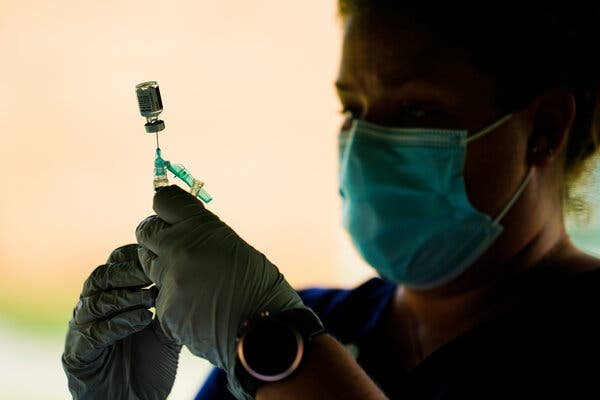 Preparing a syringe with the Pfizer-BioNTech coronavirus vaccine at a clinic at the Reading Area Community College in Reading, Pa., this week.