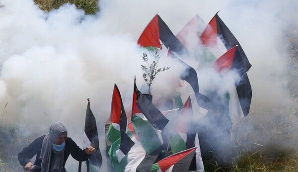 Israeli soldiers firing tear gas at Palestinians during a protest marking the 72nd anniversary of Nakba in the West Bank last year.