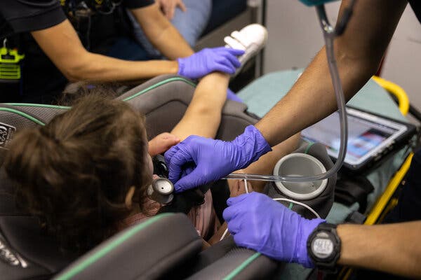 Medics from the Houston Fire Department checked the breathing of a Covid-19 positive girl, age 2, before transporting her to a hospital in Houston, Texas, earlier this week.