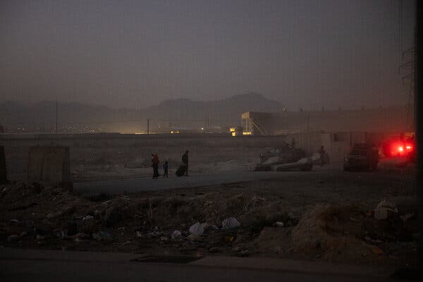 Families hoping to flee the country arriving at the airport in Kabul last week.