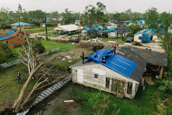 Homes in Lake Charles, La., were covered with blue tarps after being hit by Hurricane Laura. Then Hurricane Delta swept through, knocking down trees and scattering debris from the previous storm.