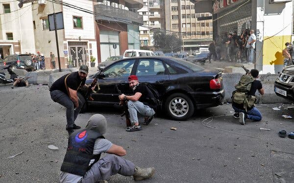 Fighters from the Shiite Hezbollah and Amal movements in the area of Tayouneh, a southern suburb of Beirut, on Thursday.