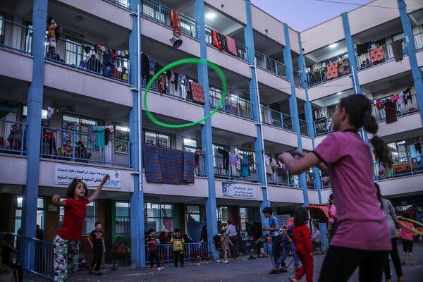 Palestinian children and their families took refuge at a U.N. school in Gaza City on Wednesday. The United Nations has warned of a potential virus surge as tens of thousands of Gazans took shelter in U.N. schools.