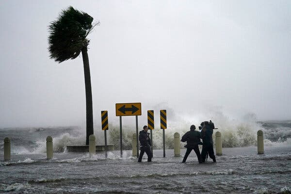 A news crew reports on the edge of Lake Pontchartrain as Hurricane Ida approaches in New Orleans today.