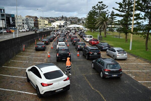 Cars lined up at a drive-through testing site in Sydney, Australia, on Monday.