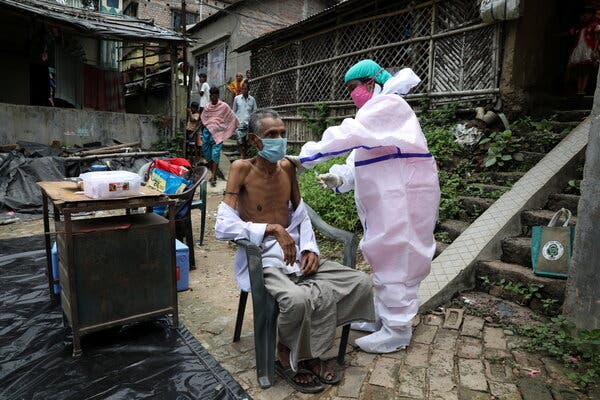Receiving a Covid shot during a door-to-door vaccination and testing drive in West Bengal State, India, on Monday.