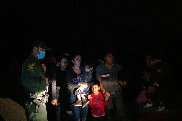Migrants were met by members of the Border Patrol after crossing from Mexico into the United States by inflatable raft at a short stretch of the Rio Grande.