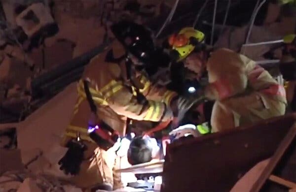 Jonah Handler, 15, the son of Stacie Fang, being hoisted out of the wreckage by emergency workers on Thursday.