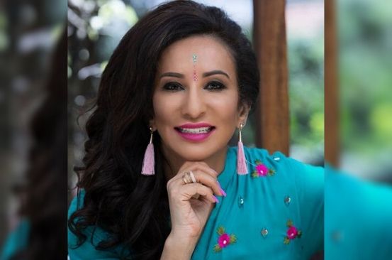 Achieving woman: Gina Din bags prestigious award