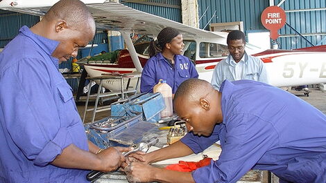 Kenyan workers at an airplane hangar.