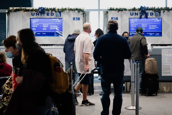 A United Airlines gate agent this week in Denver. United joined many other airlines in canceling flights over Christmas.