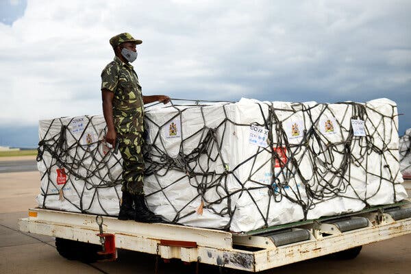 A police officer at the Kamuzu International Airport in Malawi guarded a shipment of AstraZeneca vaccines after it arrived through Covax, a vaccine-sharing partnership.
