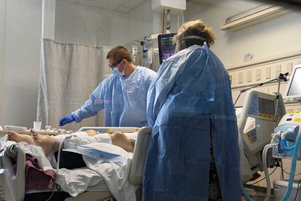 Tending to a patient in the intensive care unit at East Alabama Medical Center in Opelika, Ala., in December. Only about 47 percent of people in the state are at least partially vaccinated, compared with 60 percent nationally.