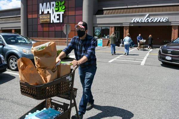 Joe Glickman, wearing two masks and goggles, grocery shopping at Price Chopper.