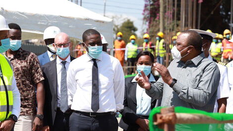 President Uhuru Kenyatta (right) speaks Nairobi Senator Johnson Sakaja (left) during a tour of Nairobi Metropolitan Services's projects in Nairobi's informal settlements on Tuesday, June 30, 2020