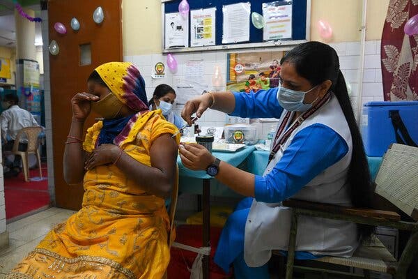 A health worker inoculating a woman with the Covaxin vaccine at a health centre in New Delhi, India, on Thursday.