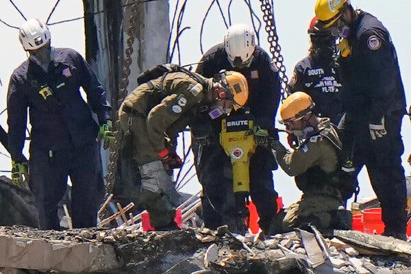 Two members of an Israeli rescue team working with American crews in the rubble at the Champlain Towers South Condo last month.