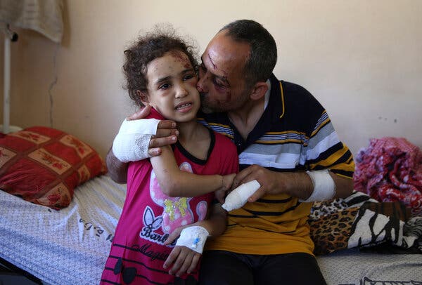 Riad Ishkontana, 42, kissed his daughter, Suzy, 7, at Shifa Hospital in Gaza City on Tuesday. They were pulled from the rubble of their home after an Israeli airstrike killed his wife and their four other children.