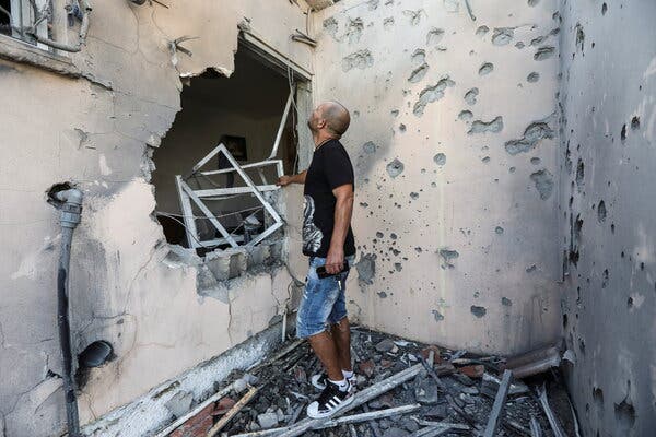 Assessing the damage in Sderot, Israel, after a rocket fired from Gaza hit a house.