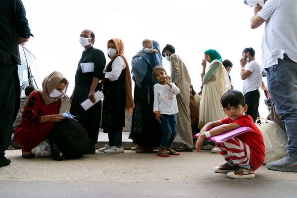 Families who were evacuated from Afghanistan waited on Monday to board buses at Washington Dulles International Airport in Virginia.