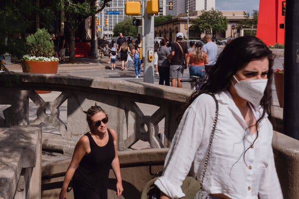 People wearing and not wearing masks in San Antonio, Texas, this month.