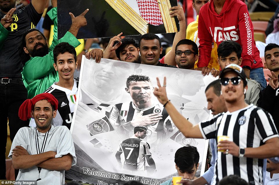Juventus supporters pose with a poster of Ronaldo in the stands during theÂ Italian Super Cup final on Wednesday night