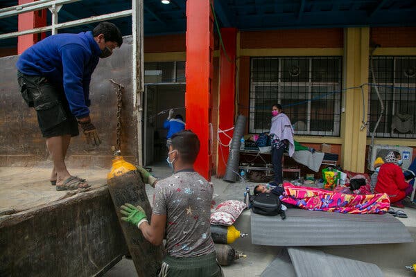 Unloading an oxygen cylinder as a patient lay outside the emergency ward of a hospital in Kathmandu, Nepal, on Monday.
