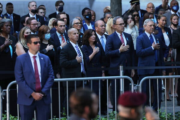 Gov. Kathy Hochul, center, during the singing of the national anthem at the National 9/11 Memorial & Museum in New York on Saturday.