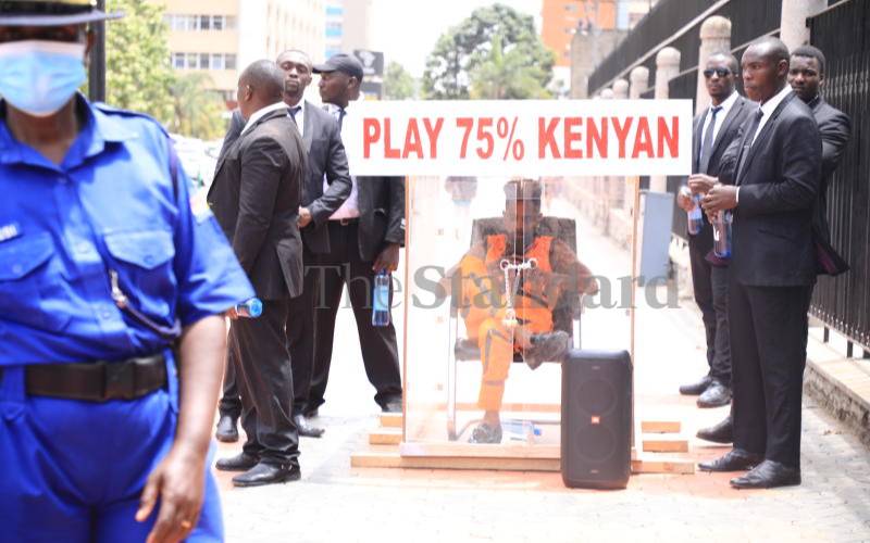 Eric Omondi locks himself in transparent cube outside parliament