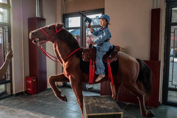 Posing for a photo in a Red Army costume at a new theme park in Yan’an.