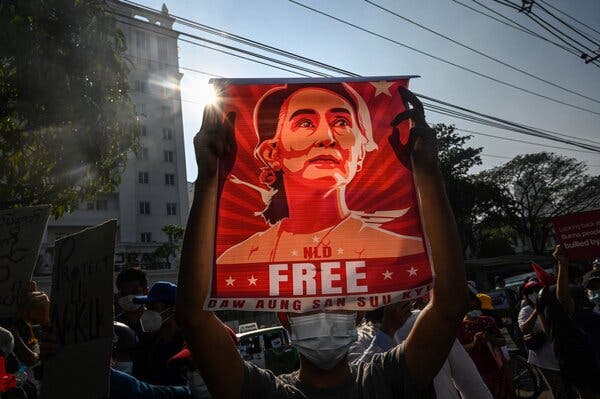 A protester holding up a poster featuring Aung San Suu Kyi during a demonstration against the military coup in front of the Central Bank of Myanmar in Yangon in February. 