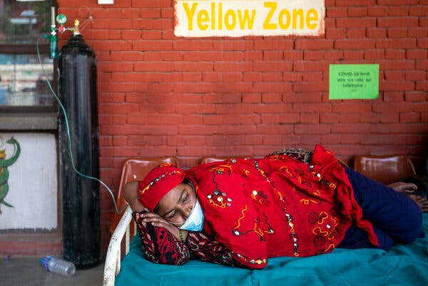 A patient received oxygen outside the emergency ward of a hospital in Kathmandu, Nepal, on Friday.