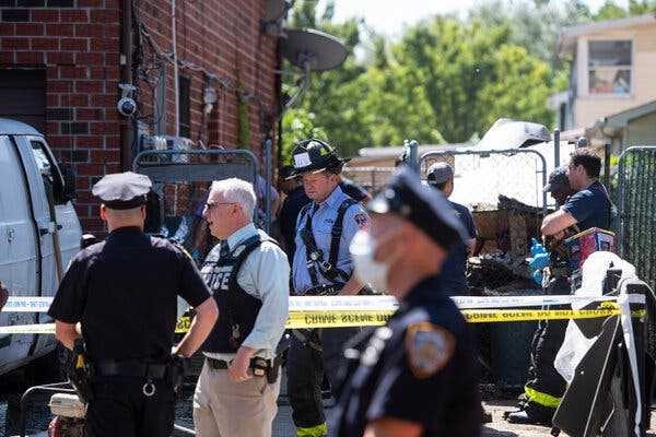 The authorities responding to a basement apartment in Queens on Thursday, where flooding killed three people.
