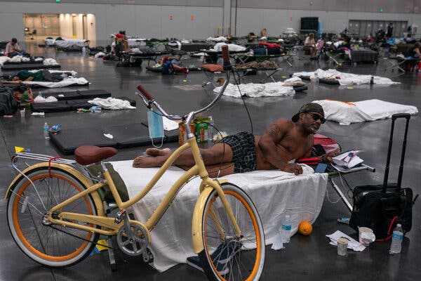 Oregon officials say no one will be turned away from cooling centers because of Covid restrictions, which are expected to end in the state by June 30. Kermic Luster rested in a cooling center at the Oregon Convention Center in Portland on Sunday.