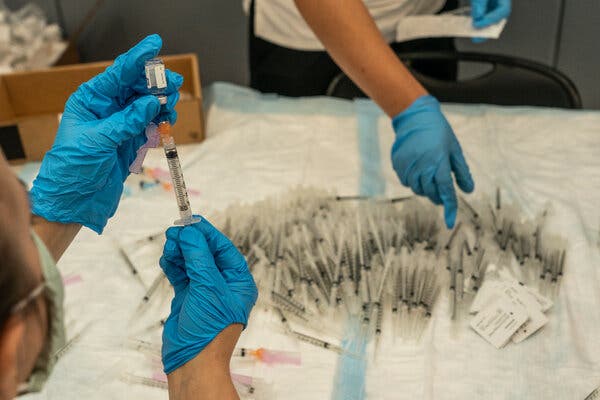 Preparing Johnson &amp; Johnson coronavirus vaccine in Houston in March.