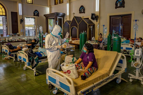 A health care worker treated Covid-19 patients on Wednesday at a chapel converted into an intensive care unit in Manila. Deaths from Covid have been rising recently in the Philippines.