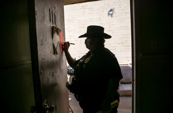 A Maricopa County constable signing an eviction notice in Phoenix last year.