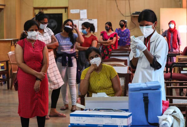 Administering Covishield, the Serum Institute version of the AstraZeneca vaccine, in Bengaluru, India.