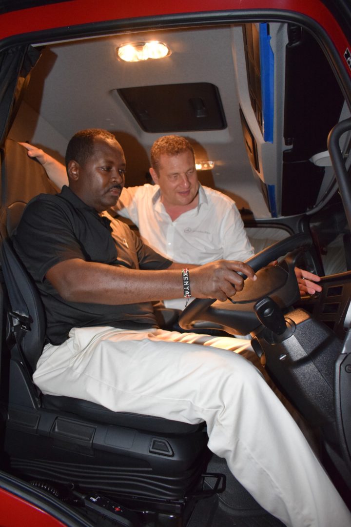 Torsten Bauerheim (right), Head of Sales and Customer Service Mercedes-Benz Trucks, Daimler shows the new Mercedes-Benz Actros 3342 to Anthony Maina (left), the DT Dobie, Mombasa Branch Manager.
