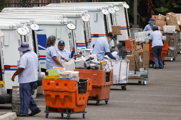 Postal workers loading trucks in Carlsbad, Calif., on Monday.