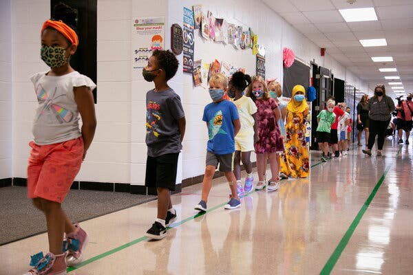 Masked and distanced children heading to lunch at Wilder Elementary School in Louisville, Ky., as fall classes began in the state’s public schools on Aug. 11. As of Friday, 34 of the state’s 171 school districts had at some point closed because of coronavirus outbreaks and quarantines.