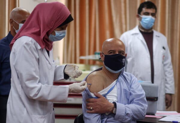 A staff member of the World Health Organization receives a Covid vaccine in March in Gaza City.